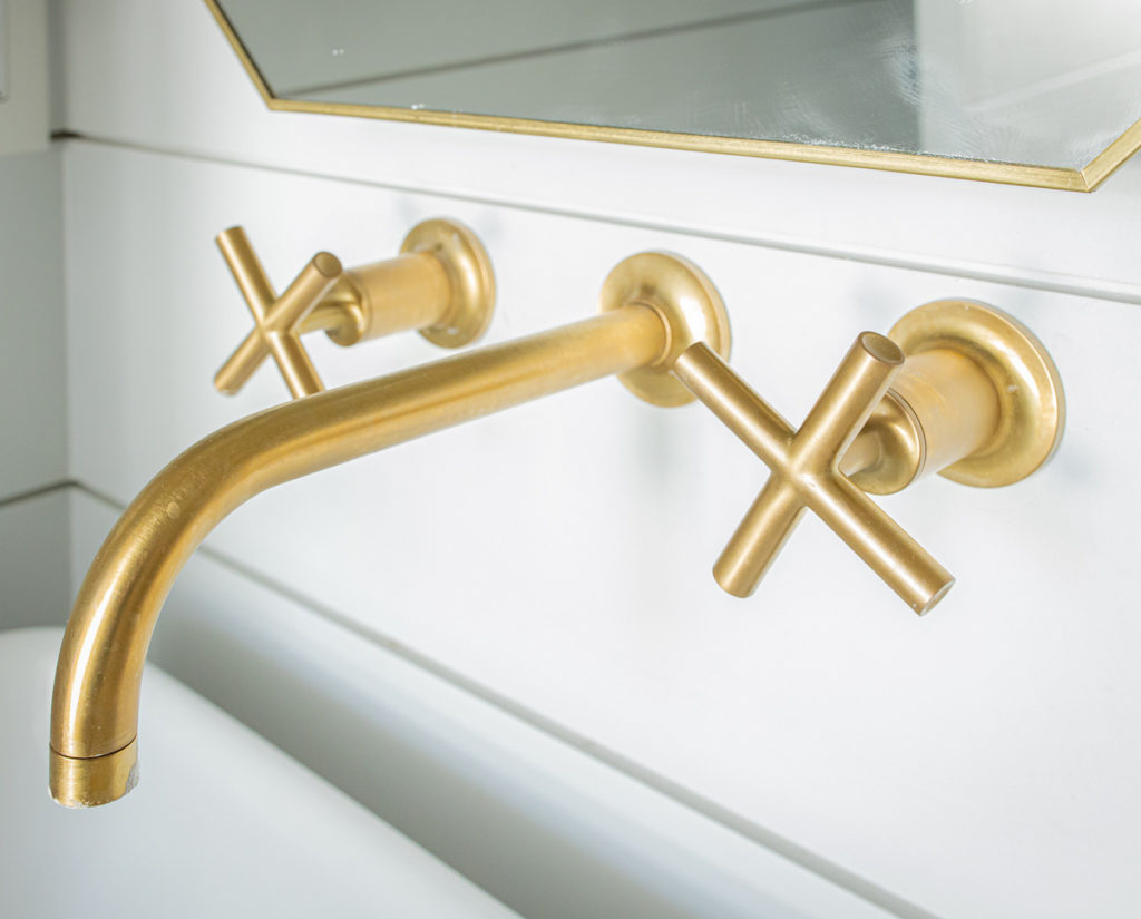 Gold Kohler faucet wall mount with cross handles